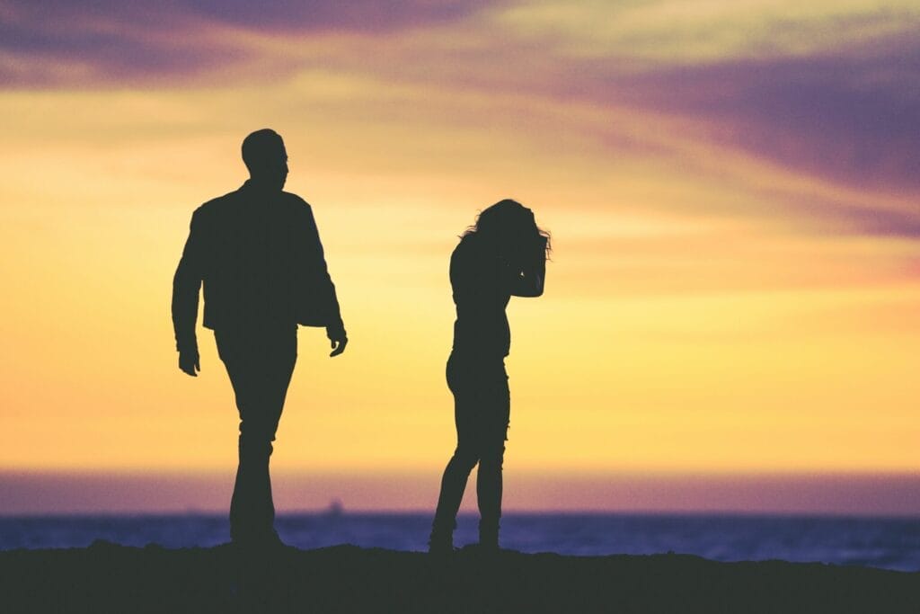 silhouette of man and woman under yellow sky illustrating the different investment paths of Terry and Sally.